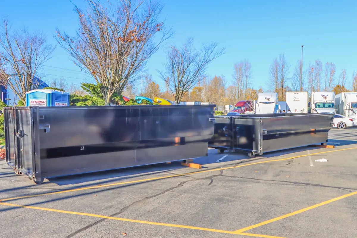 Professional dumpster rental service with roll-off container on residential driveway in Parma